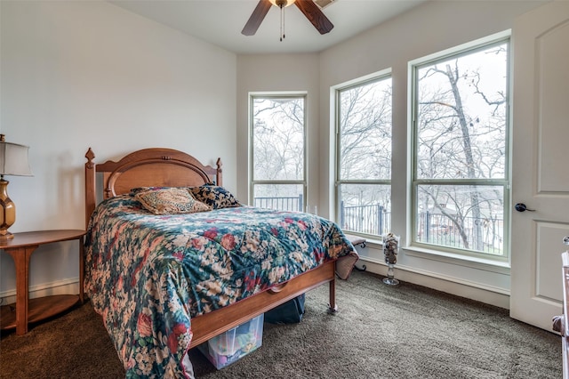 carpeted bedroom featuring a ceiling fan and baseboards