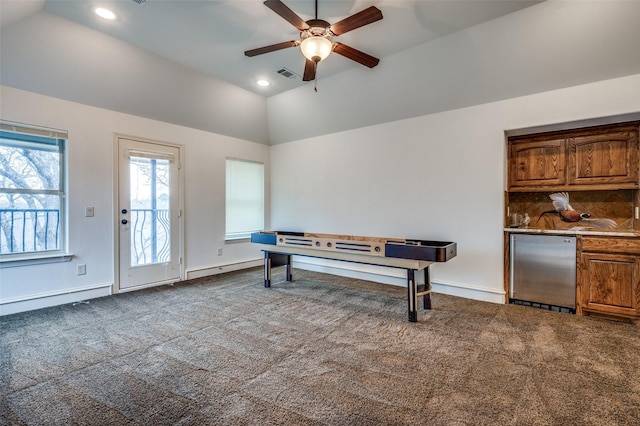 interior space featuring visible vents, a ceiling fan, lofted ceiling, dark colored carpet, and recessed lighting