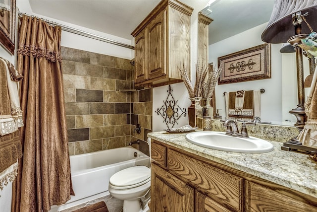 bathroom with shower / bath combo, vanity, and toilet