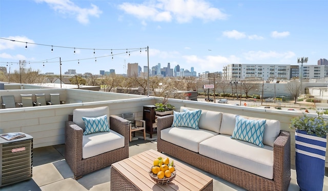 view of patio / terrace featuring outdoor lounge area and a city view