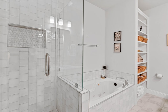 bathroom with a stall shower, baseboards, a tub with jets, and marble finish floor