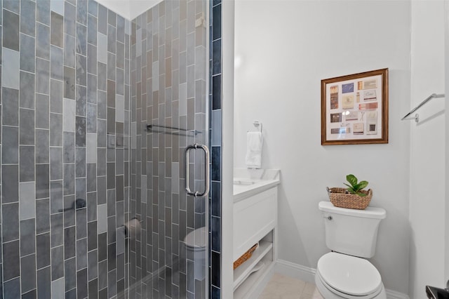 bathroom with toilet, vanity, baseboards, a shower stall, and tile patterned floors