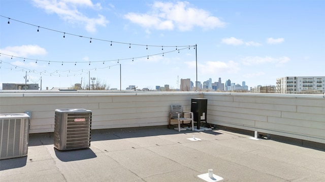 view of patio / terrace with cooling unit and a city view