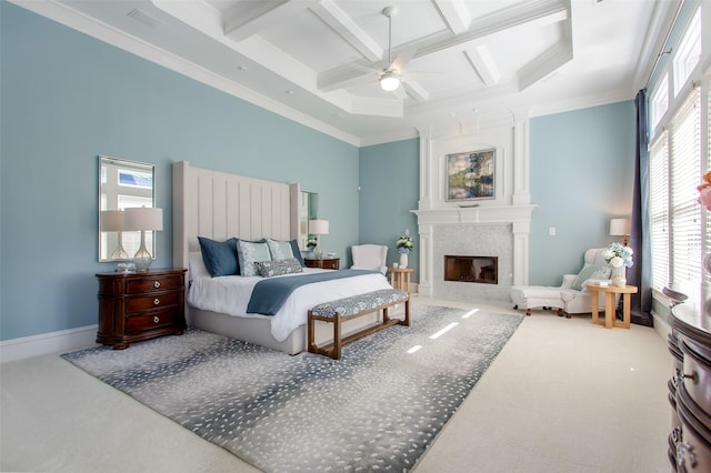 carpeted bedroom with coffered ceiling, ornamental molding, and a high end fireplace