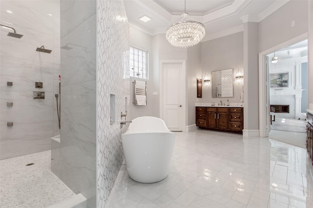 full bathroom with vanity, a marble finish shower, a soaking tub, a fireplace, and ornamental molding