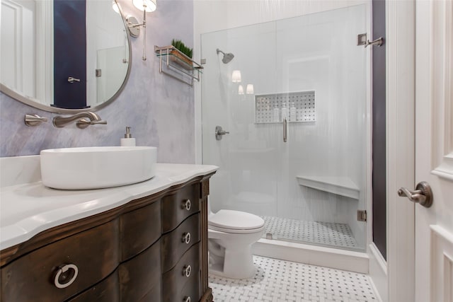 bathroom featuring vanity, toilet, and a stall shower