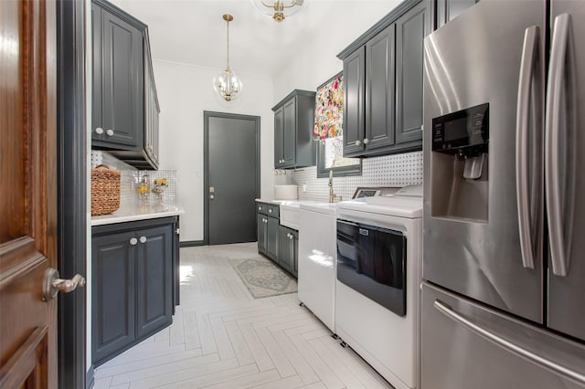 kitchen featuring tasteful backsplash, light countertops, stainless steel refrigerator with ice dispenser, and separate washer and dryer