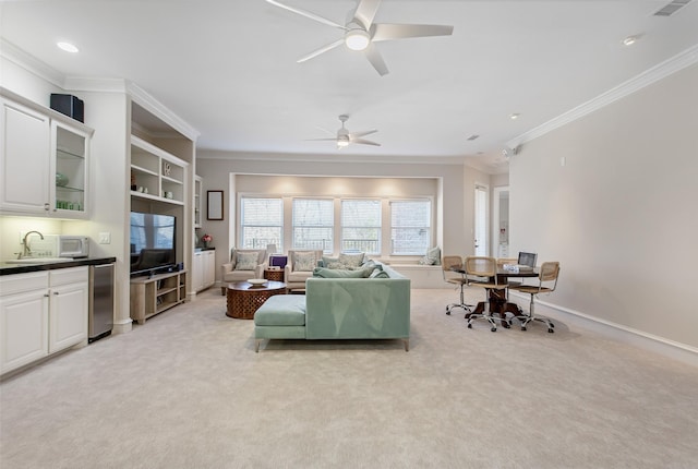 living room with light colored carpet, crown molding, and baseboards