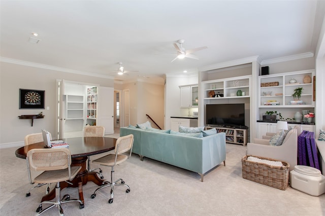 living room featuring light colored carpet, baseboards, crown molding, and a ceiling fan