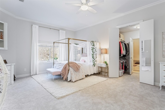 bedroom featuring a walk in closet, crown molding, and carpet floors