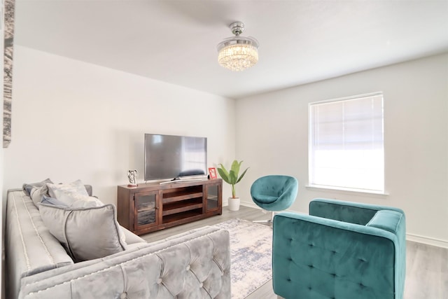 living area with wood finished floors and baseboards