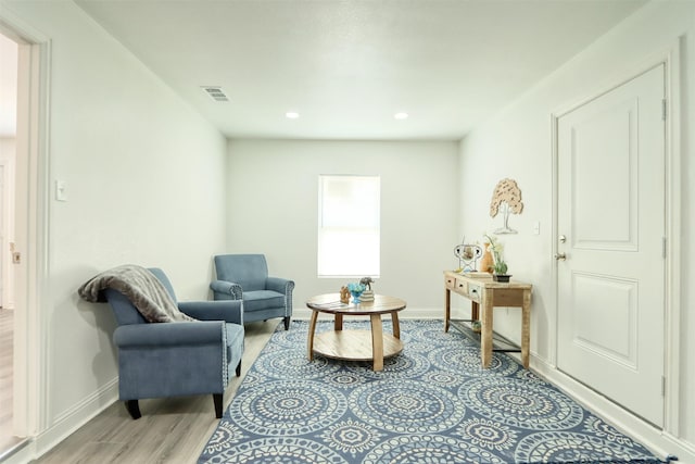 sitting room with light wood-style flooring, visible vents, baseboards, and recessed lighting