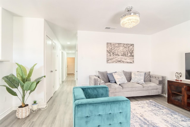 living room featuring visible vents and wood finished floors