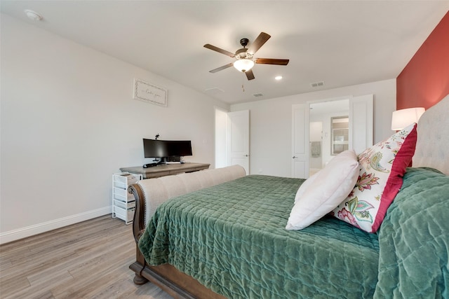 bedroom with ceiling fan, light wood-style flooring, visible vents, and baseboards