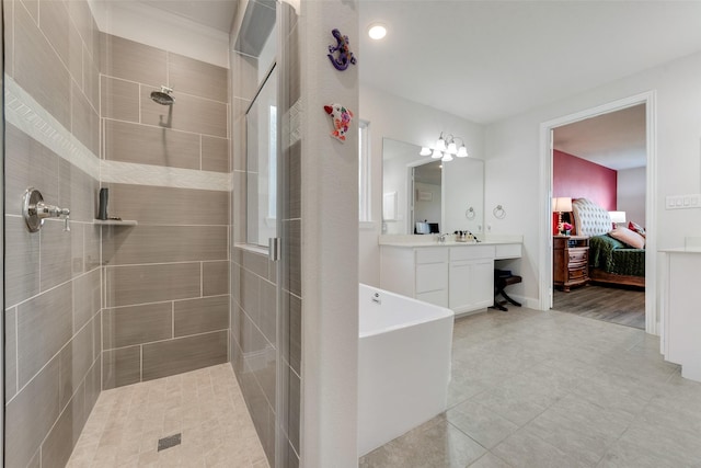 ensuite bathroom featuring ensuite bath, baseboards, a tile shower, and vanity