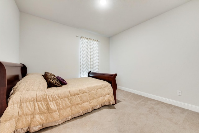 carpeted bedroom featuring baseboards