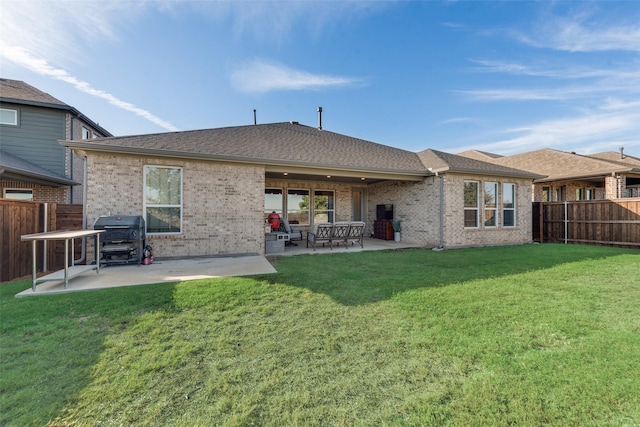 back of property with a patio area, a fenced backyard, and a yard