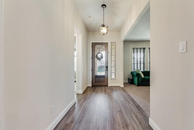 foyer featuring dark wood finished floors and baseboards