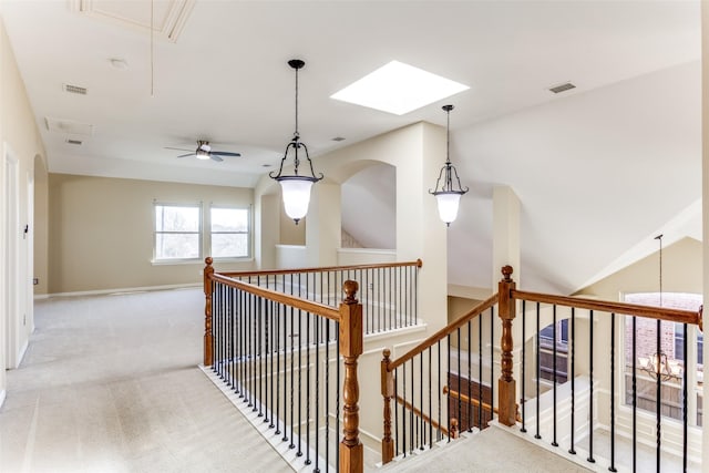 hallway featuring visible vents, attic access, carpet flooring, an upstairs landing, and baseboards