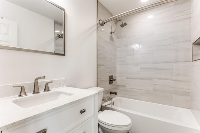 bathroom with washtub / shower combination, vanity, and toilet