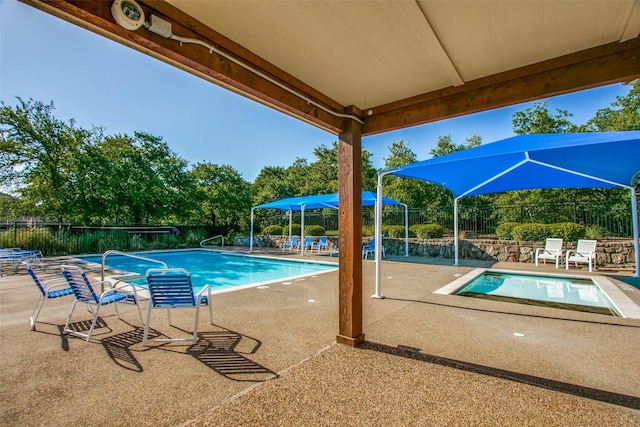 view of swimming pool featuring a patio area, fence, and a fenced in pool