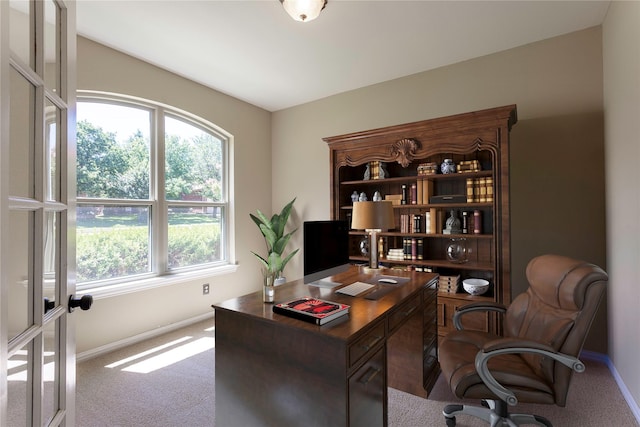 carpeted office featuring baseboards