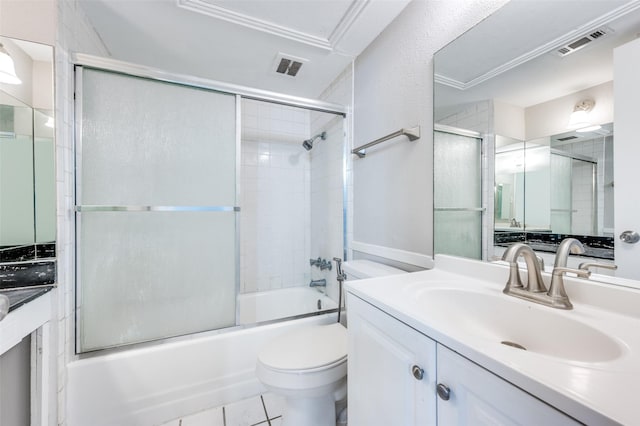 bathroom with enclosed tub / shower combo, visible vents, vanity, and toilet