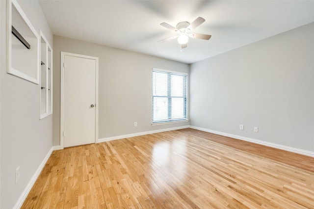 unfurnished room featuring ceiling fan, baseboards, and light wood-style floors