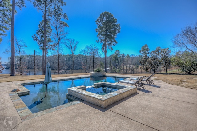 view of swimming pool featuring a patio area and a pool with connected hot tub