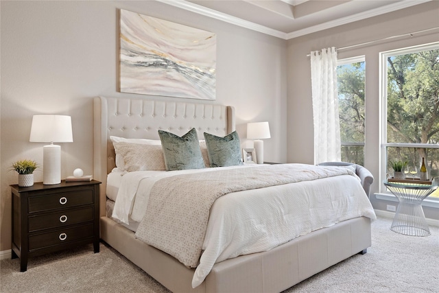 bedroom featuring baseboards, crown molding, and light colored carpet