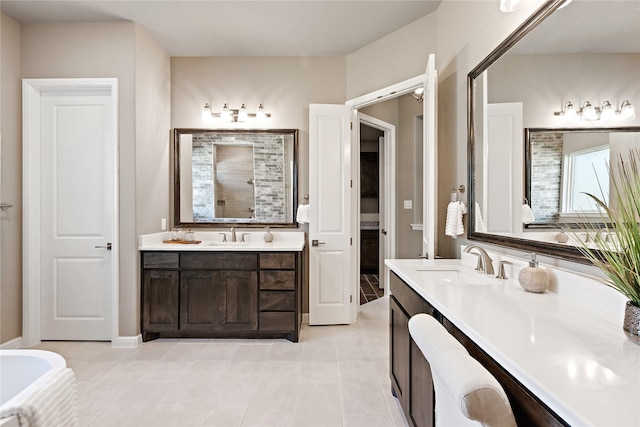 full bath featuring two vanities, a sink, a shower stall, and tile patterned floors