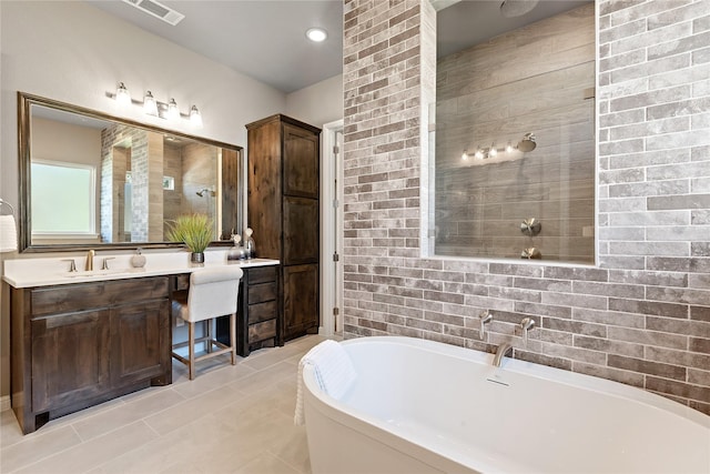 bathroom featuring visible vents, tiled shower, tile patterned flooring, vanity, and a freestanding tub