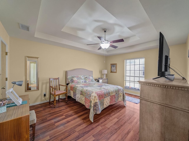 113 S Beltwoods Dr, Desoto, TX 75115 - bedroom with baseboards, visible vents, a tray ceiling, and wood finished floors