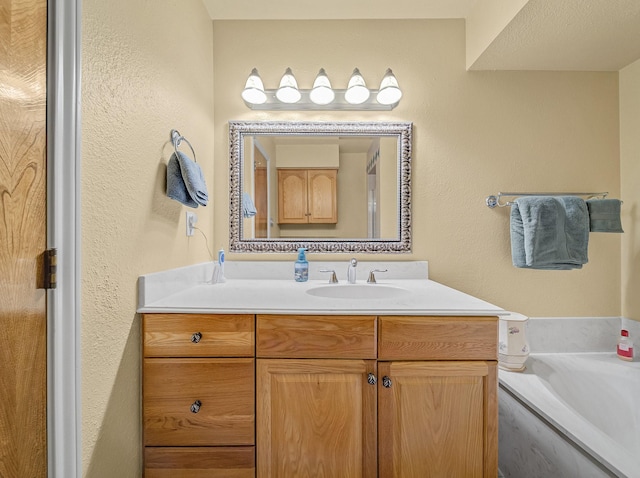 113 S Beltwoods Dr, Desoto, TX 75115 - bathroom with a garden tub, a textured wall, and vanity