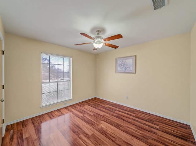 113 S Beltwoods Dr, Desoto, TX 75115 - spare room featuring a ceiling fan, wood finished floors, visible vents, and baseboards