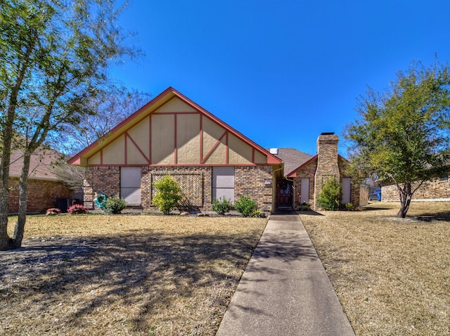 english style home featuring stucco siding and brick siding