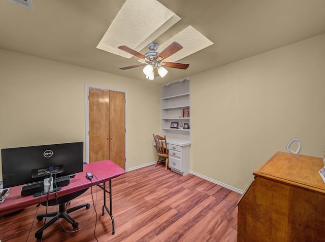 113 S Beltwoods Dr, Desoto, TX 75115 - home office with light wood-type flooring, a skylight, a ceiling fan, and baseboards