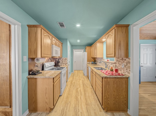 113 S Beltwoods Dr, Desoto, TX 75115 - kitchen with white appliances, visible vents, light wood finished floors, and a sink