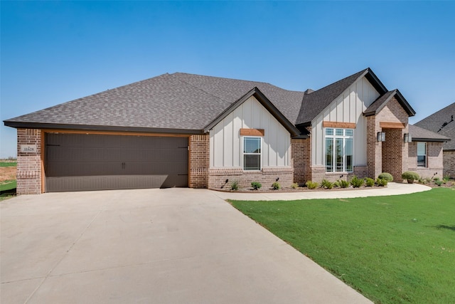 view of front of house featuring brick siding, roof with shingles, board and batten siding, driveway, and a front lawn