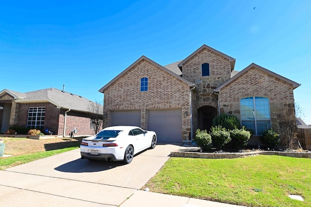 view of front of property featuring driveway, a garage, stone siding, a front yard, and brick siding