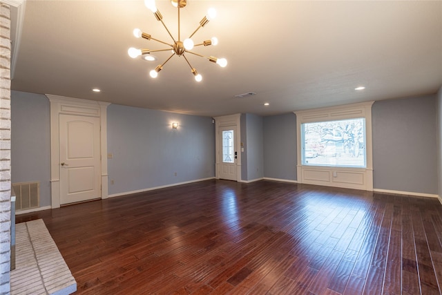 unfurnished living room with a notable chandelier, visible vents, and dark wood-type flooring