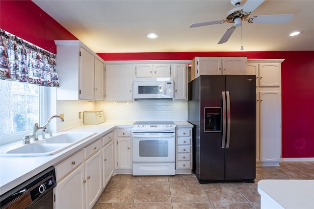 kitchen featuring tasteful backsplash, white appliances, white cabinets, and a sink