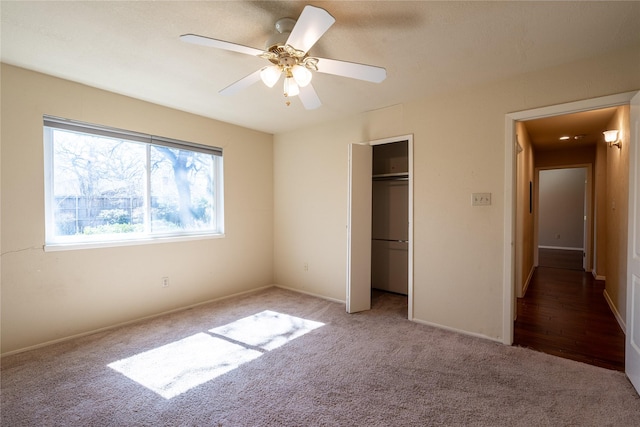 unfurnished bedroom with a closet, light carpet, and ceiling fan