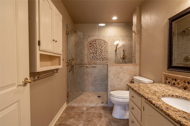 bathroom featuring recessed lighting, toilet, vanity, tiled shower, and tile patterned floors