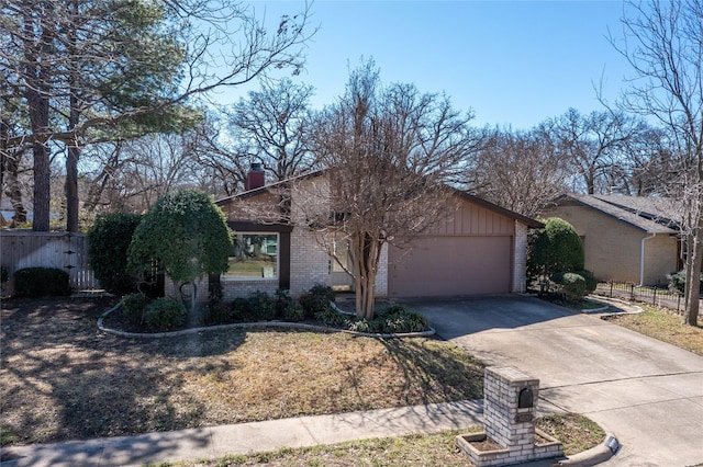 view of front facade featuring brick siding, a chimney, concrete driveway, fence, and a garage