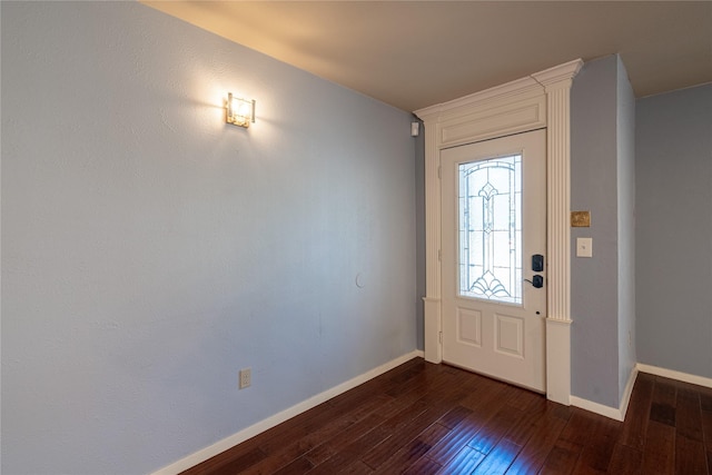 foyer featuring dark wood-style flooring and baseboards