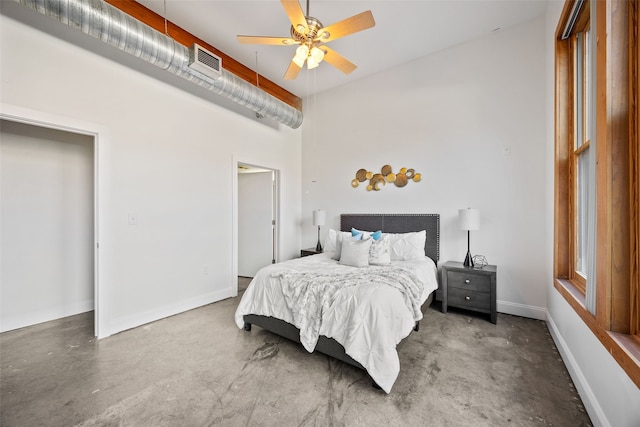 bedroom featuring ceiling fan, concrete floors, visible vents, and baseboards