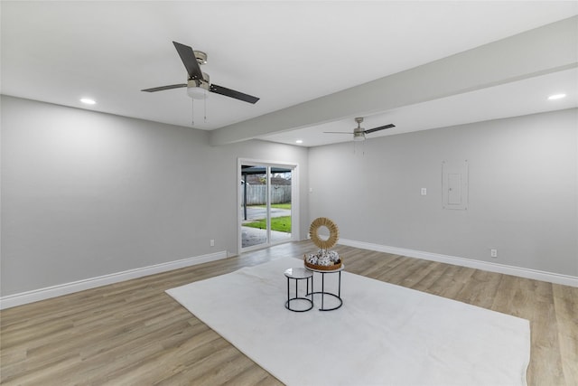 living area featuring recessed lighting, light wood-type flooring, and baseboards