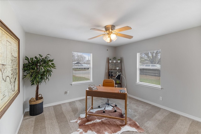 office space featuring a ceiling fan, baseboards, and carpet flooring