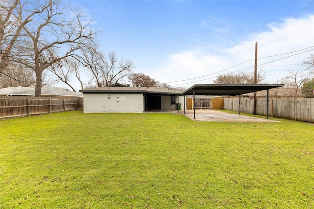 back of house featuring a patio, a yard, and a fenced backyard